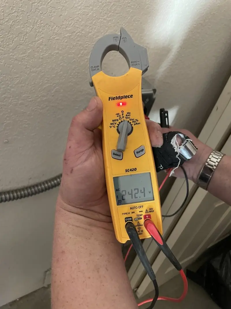 Voltage testing with clamp meter during Whole House Surge Protector in Parker